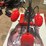 Red document camera with two bulb-style lamps and adjustable stand