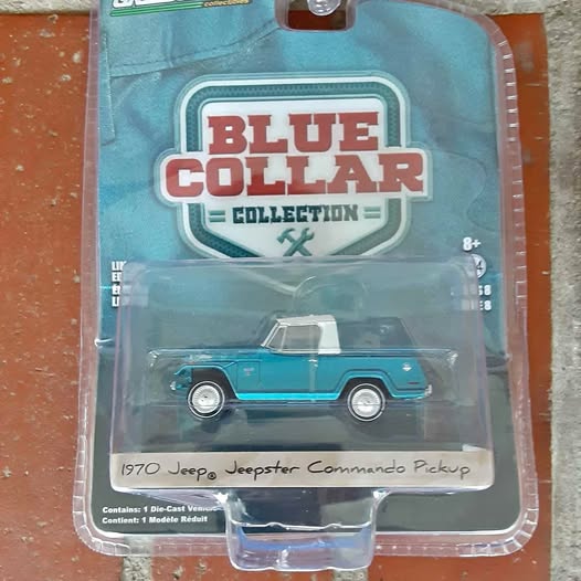 Blue 1970 Jeep Commander pickup diecast in blister package, with logo card