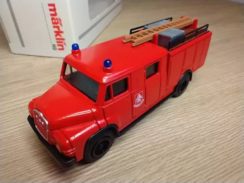 Red diecast fire engine model truck, front view, HO scale