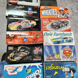 Diecast car lot in boxed NASCAR-style racing designs, stacked in two rows