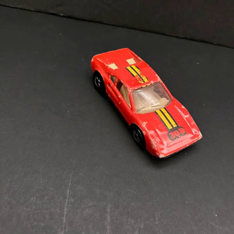 Vintage Ferrari 308 diecast sports car, red with yellow racing stripes and opening hood