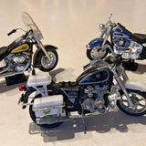 Diecast motorcycle model in blue with chrome details, kickstand and front wheel visible