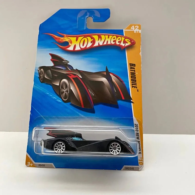 Hot Wheels diecast car in blister pack, black body with red stripes, winged design