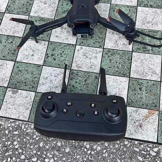 Black drone remote controller with dual joysticks and multiple control buttons
