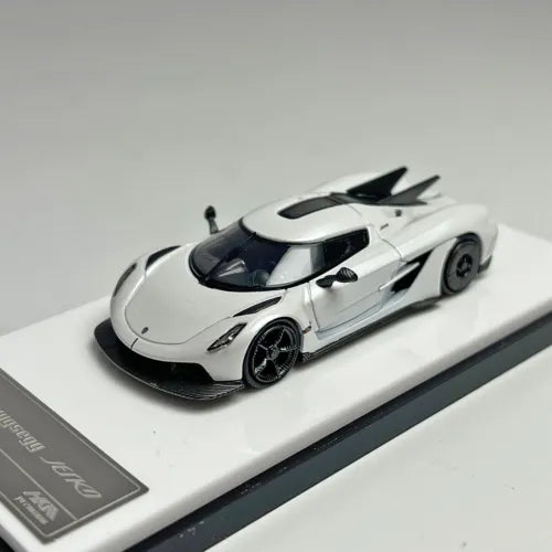 White and black 1:64 die-cast supercar model car with black rear wing