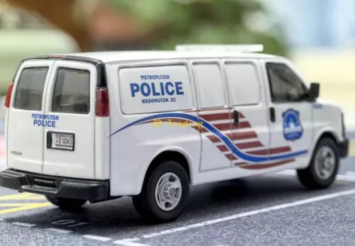 White die-cast police van model with side door and Metropolitan Police logo