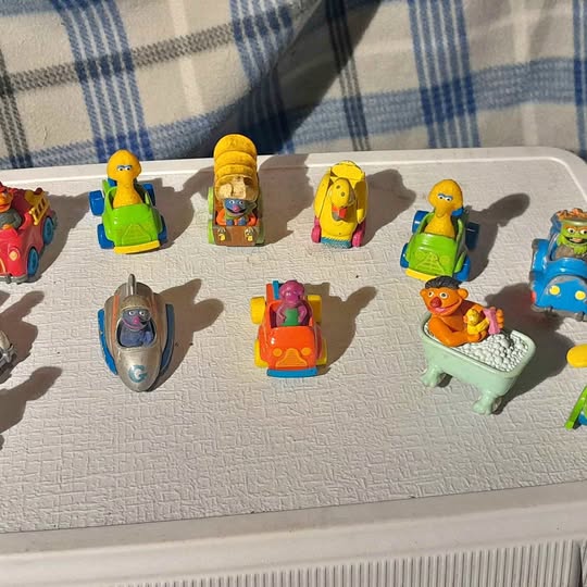 Vintage diecast bath toy figures with colorful characters, assorted poses