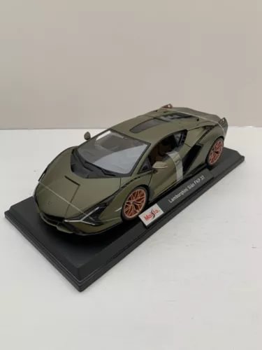 1:18 diecast sports car model in dark green with orange wheel accents on display base