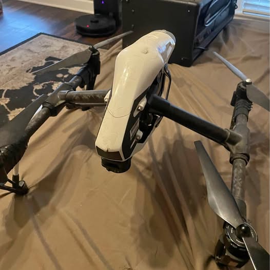DJI Inspire 1 drone with beige body, camera gimbal, and propellers