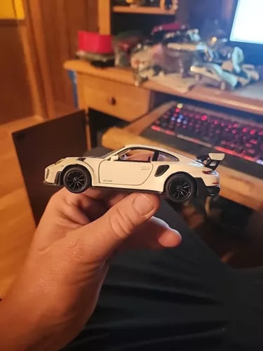 Eggshell white diecast sports car toy, front 3/4 view, black wheels, fixed hardtop