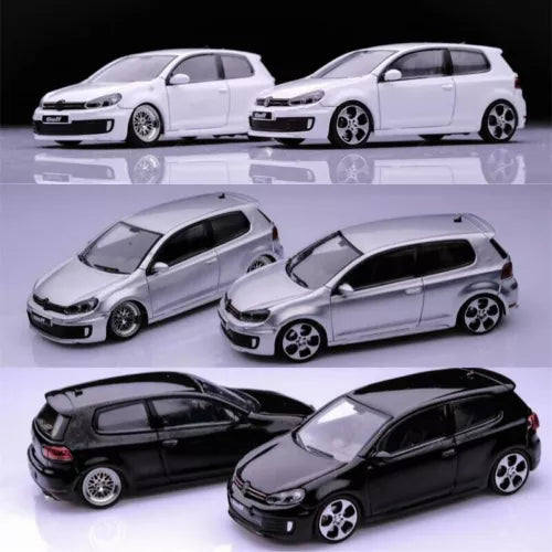 Diecast model car toy set, white and black hatchback with detailed wheels.