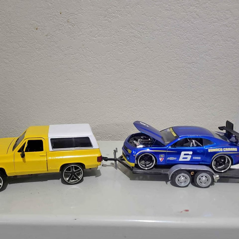 Diecast car set with yellow van and blue race car on a trailer