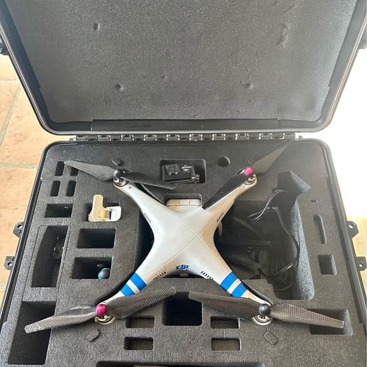 DJI drone with 2 GoPro cameras in open foam carrying case, gray and white