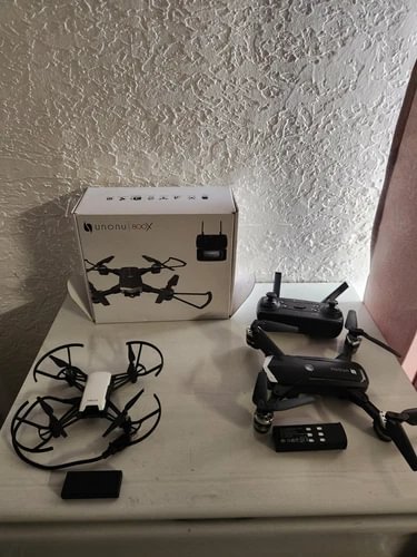 Unonu 800x drone kit with boxed drone, controller, and extra battery packs on display