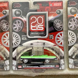 Boxed 1/64 diecast car model with black body and green top