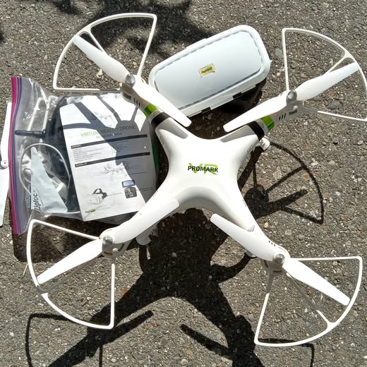 White quadcopter drone with four propellers and central body
