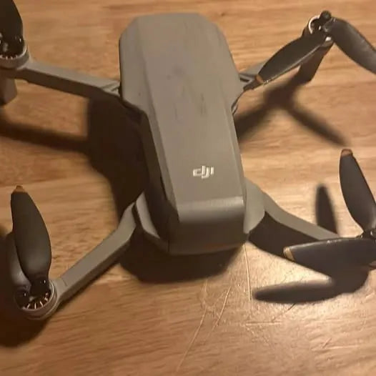 DJI Mini 2 SE drone with folded arms and visible propellers