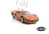 Orange diecast car ornament with hanging metal loop, front three-quarter view