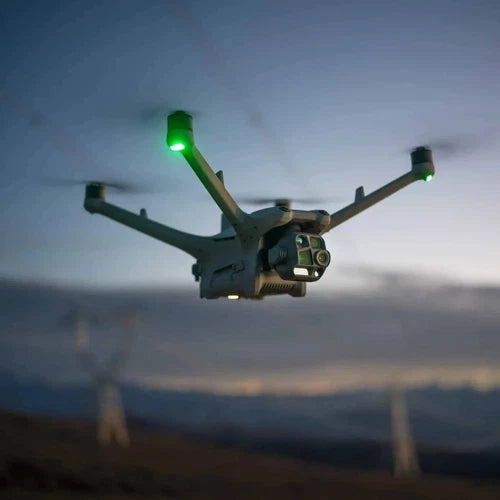 Enterprise quadcopter drone with four arms and green navigation lights in flight