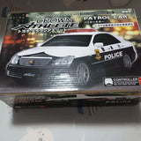 1:32 diecast police model car, black with white side stripes and POLICE decals