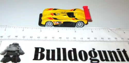 Yellow and black diecast roadster car with red rear spoiler detail