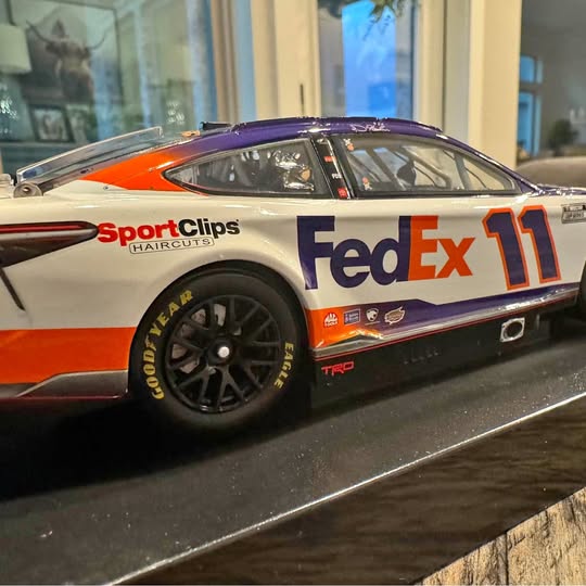 FedEx 11 NASCAR diecast race car, white orange purple, Sport Clips, front-side view