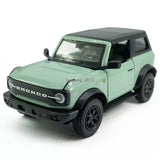 Green Bronco diecast pull-back model car with black wheels and grille detail