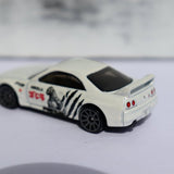 White diecast sports car model with black wheels and side racing decals