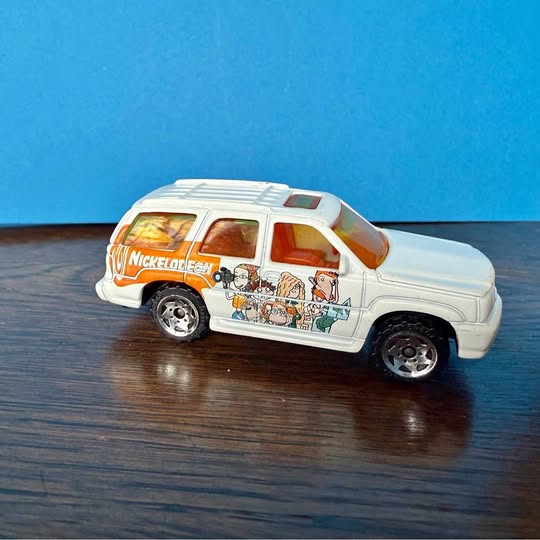 1:68 diecast SUV model, white with colorful cartoon side graphics, silver wheels