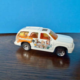 1:68 diecast SUV model, white with colorful cartoon side graphics, silver wheels