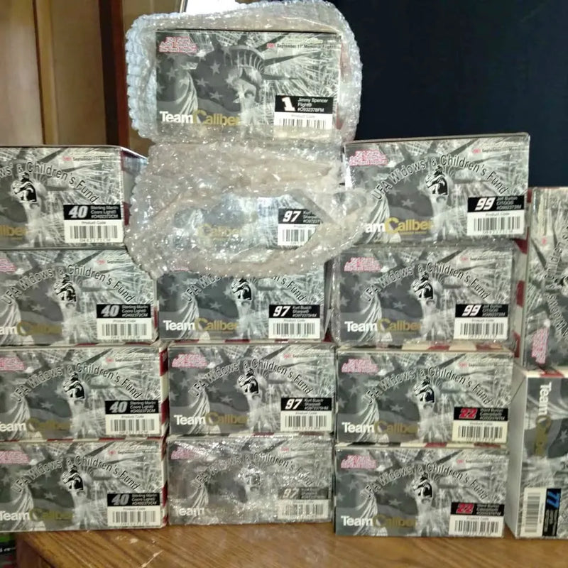 Packaged diecast car boxes with gray Team Caliber graphics, numbers 40, 97, 99