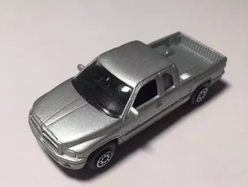 Diecast pickup truck model in silver-gray with black windows, side view