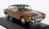 Car diecast model, caramel brown vintage sedan, front three-quarter view with grille