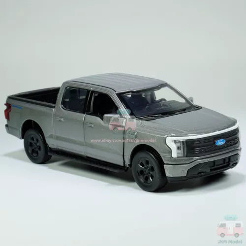 Gray 1:36 diecast toy pickup truck with black wheels and grille, front three-quarter view