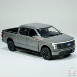 Gray 1:36 diecast toy pickup truck with black wheels and grille, front three-quarter view