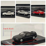 Black diecast model sedan on display base, front three-quarter view