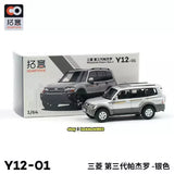 1/64 diecast SUV toy, silver with black windows, in front of gray model.