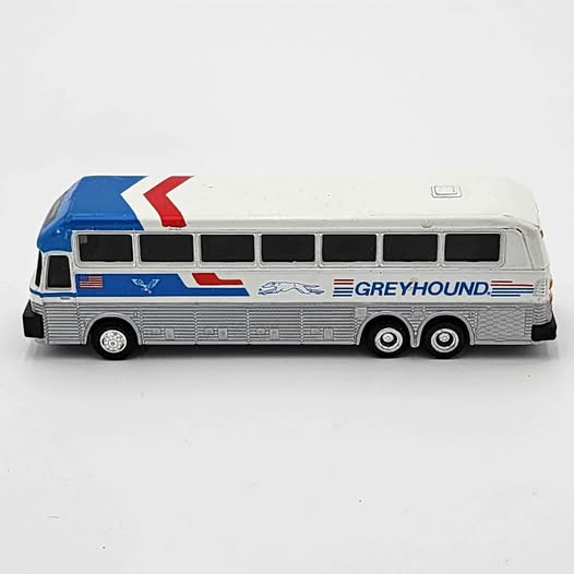 Greyhound diecast coach bus toy with blue stripe, red arrow, and black windows