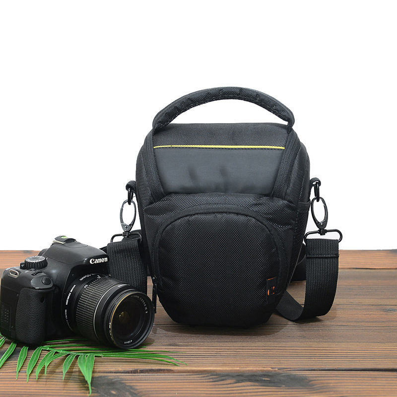 Black camera shoulder bag with top handle, front pocket, and adjustable strap
