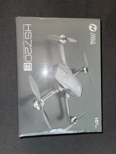 Boxed drone with three propellers and folded arms, product label on front