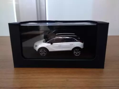 White scale diecast crossover car model with silver details, side view.