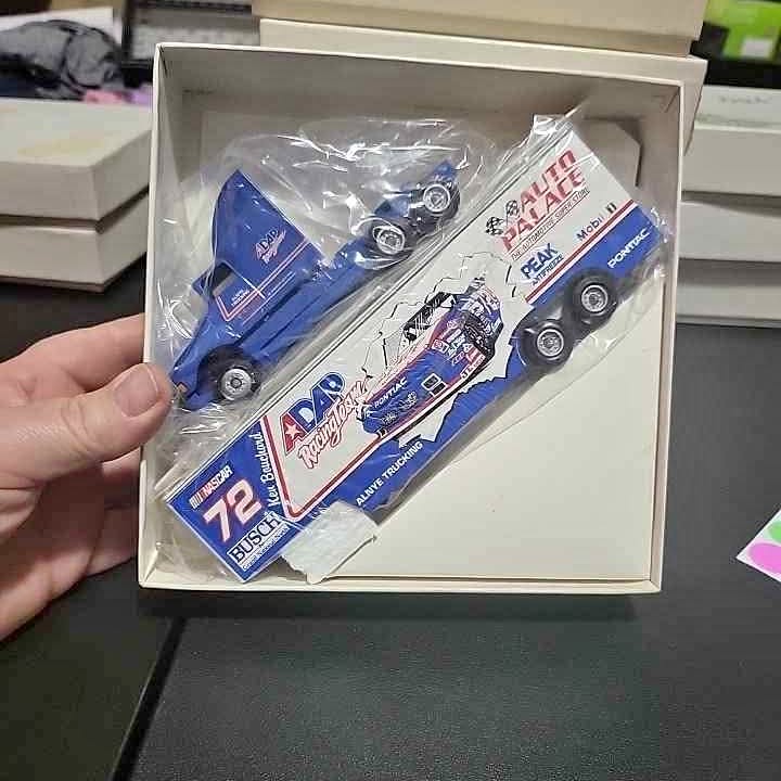 Blue 1:64 diecast semi truck model in box, front view