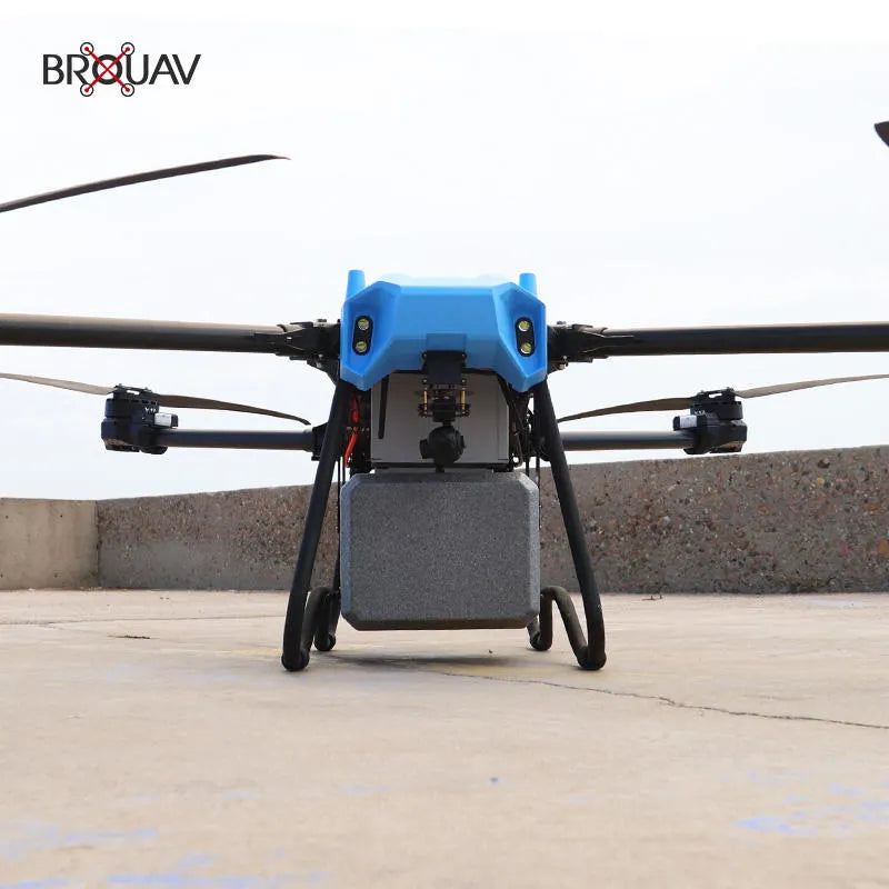 Delivery drone with blue body and four rotors, landing legs and cargo bay