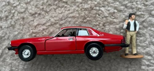 Diecast toy car replica, red Jaguar XJS with standing figure