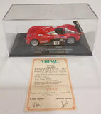 Red diecast race car model with black wheels in clear display case