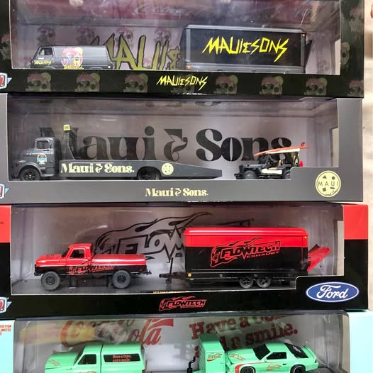 Diecast truck lot in boxed display, including red and green trucks