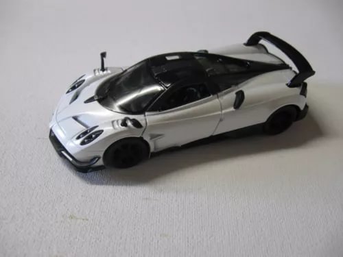 Diecast pullback sports car model in silver with black roof, front three-quarter view