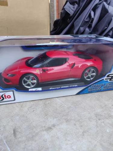 Red Ferrari 1:18 diecast model car with black wheels in display box