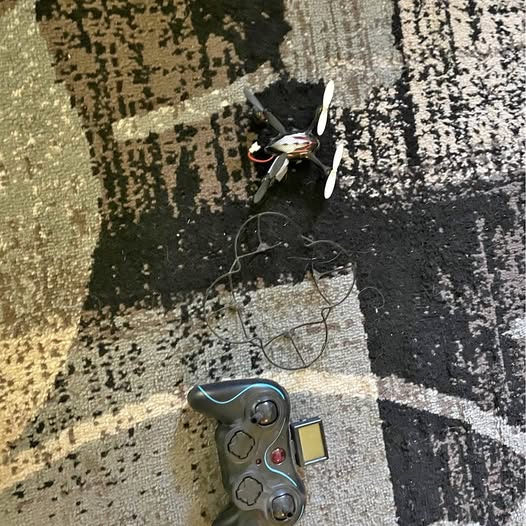 Blue and gray quadcopter drone with camera and visible propellers