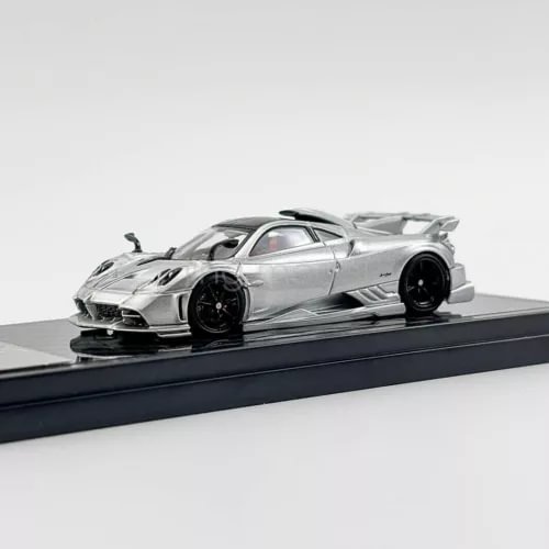 Silver 1/64 scale diecast sports car model with black wheels and rear spoiler